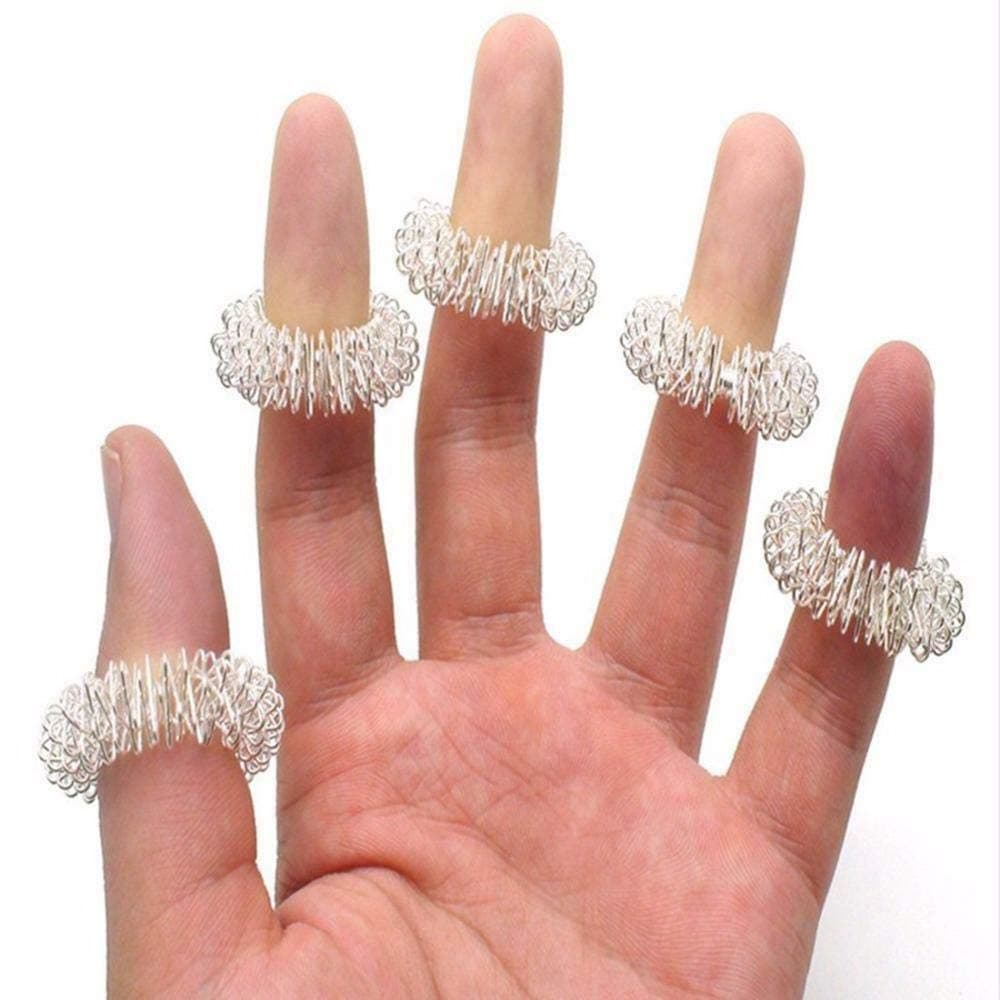 Silver acupressure ring rolling on a finger